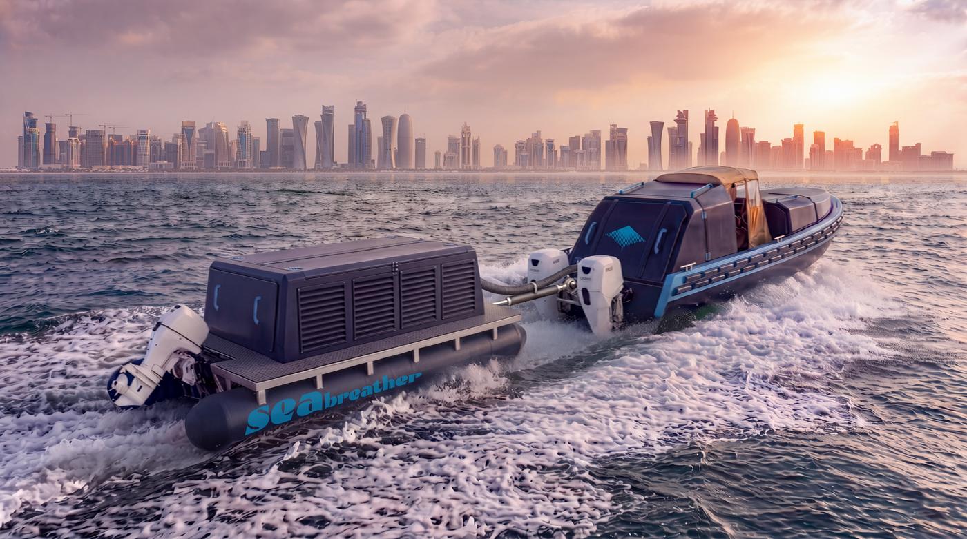 A Super SeaBreather off the Doha skyline at sunset, a second hull keeping station off its quarter